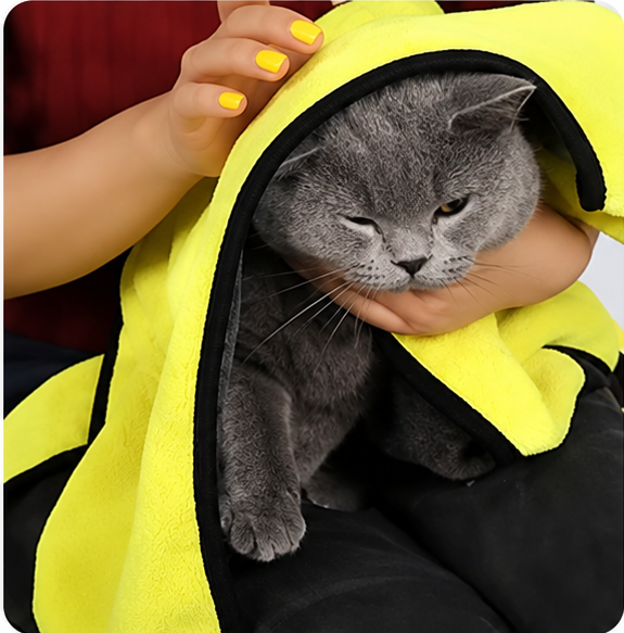 Dog wrapped in a yellow and grey pet towel