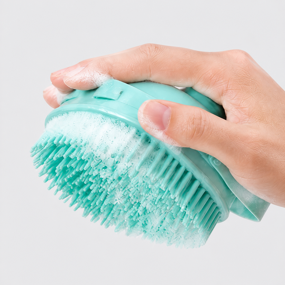 Hand holding the pet bath brush with its flexible strap